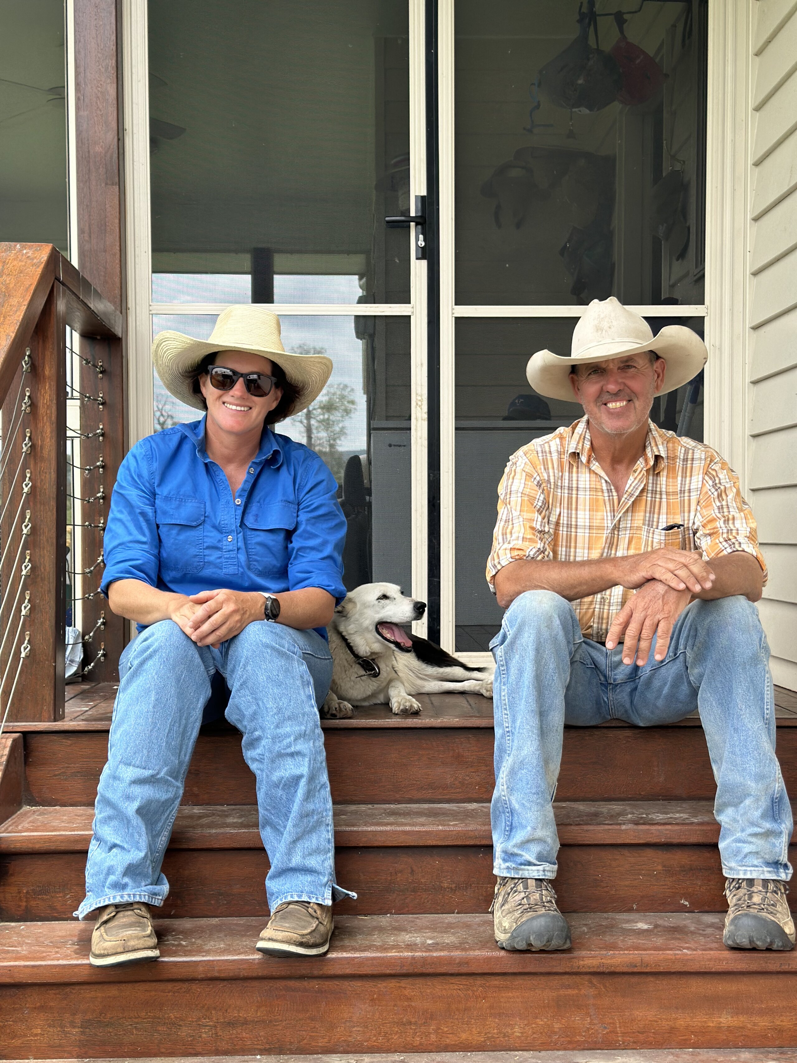 Lyndal and Geoff Nicol sitting on their porch with dog
